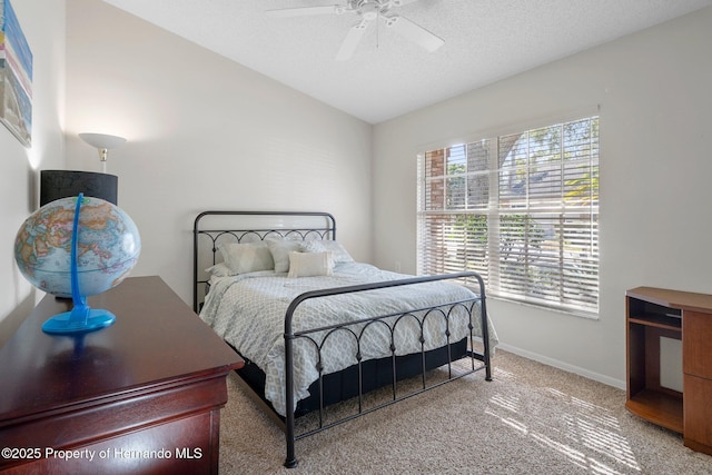 carpeted bedroom with lofted ceiling, ceiling fan, and a textured ceiling