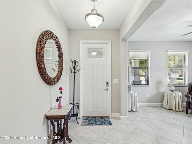 tiled foyer with ceiling fan