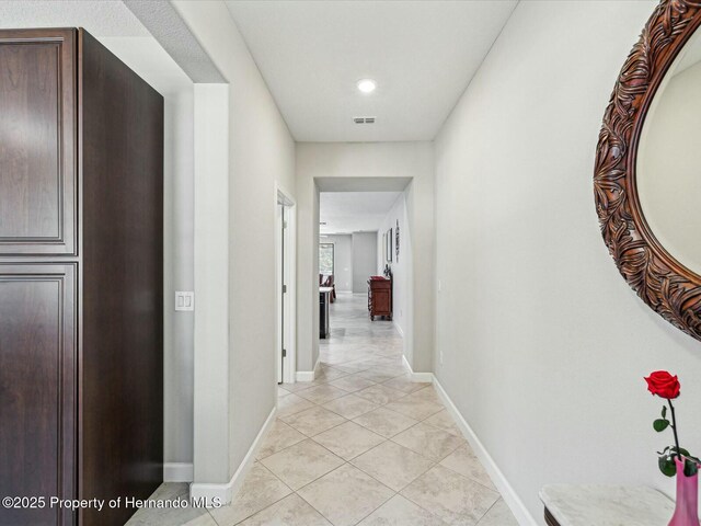 corridor with light tile patterned floors