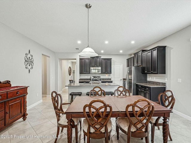 dining room featuring light tile patterned floors and sink