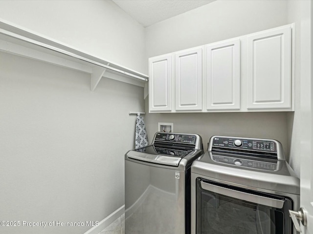 washroom with independent washer and dryer and cabinets