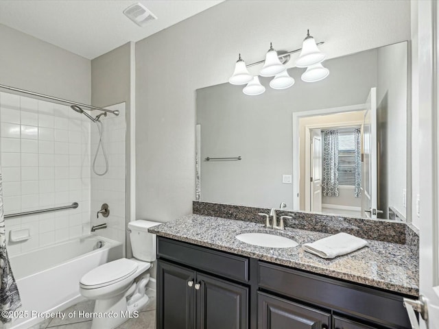 full bathroom featuring tiled shower / bath combo, vanity, tile patterned flooring, and toilet