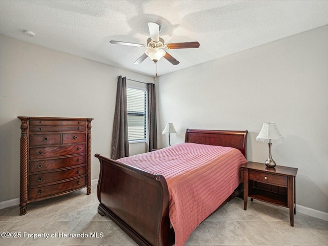 bedroom featuring a textured ceiling and ceiling fan