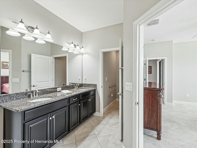 bathroom with tile patterned floors and vanity