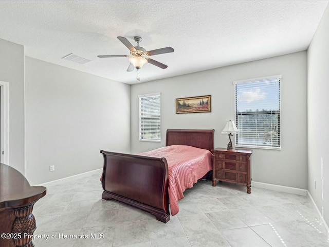 bedroom featuring a textured ceiling and ceiling fan