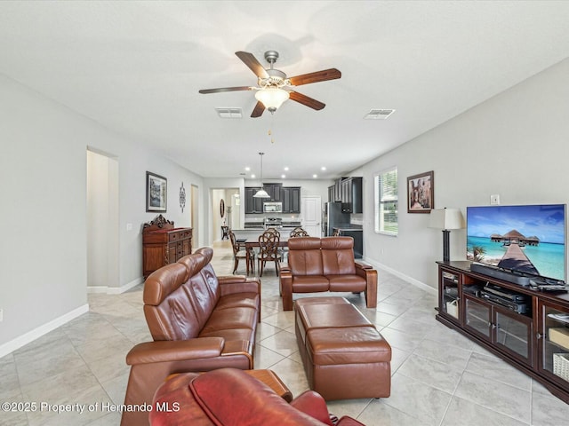 living room featuring light tile patterned flooring and ceiling fan