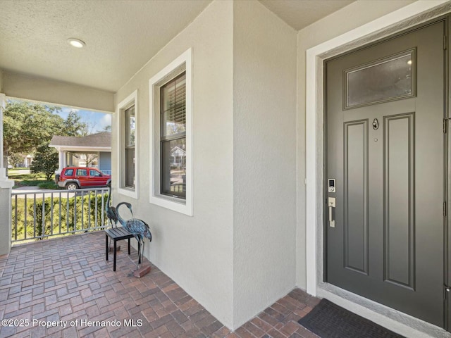 property entrance with covered porch