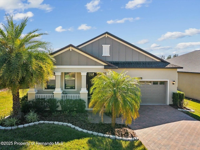 view of front of property with a garage and covered porch