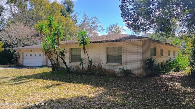 view of front of house with a garage and a front yard