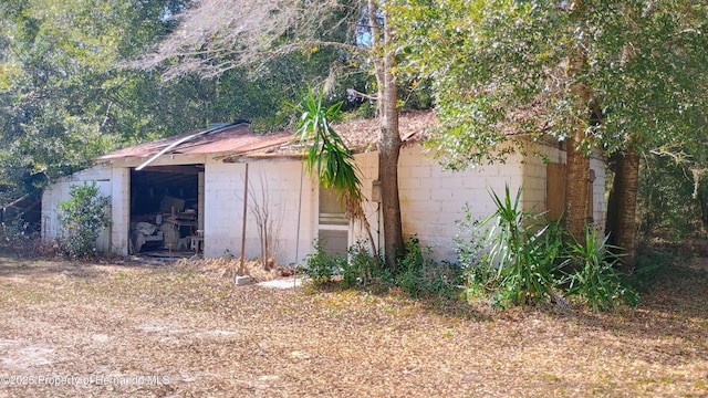 view of side of home with an outbuilding