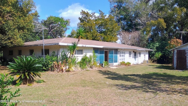 ranch-style house with a front lawn