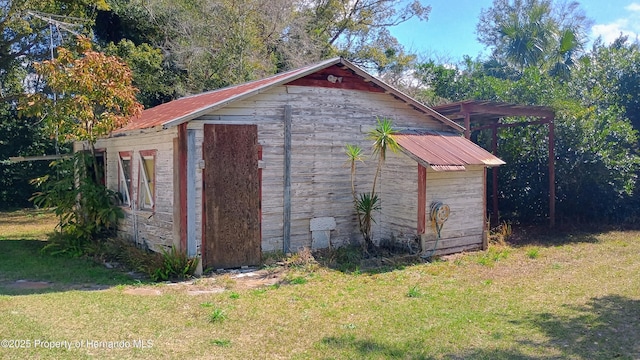 view of outdoor structure featuring a lawn