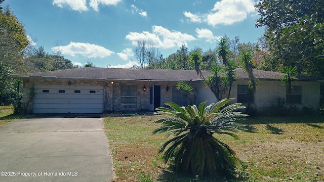 ranch-style house featuring a garage and a front lawn