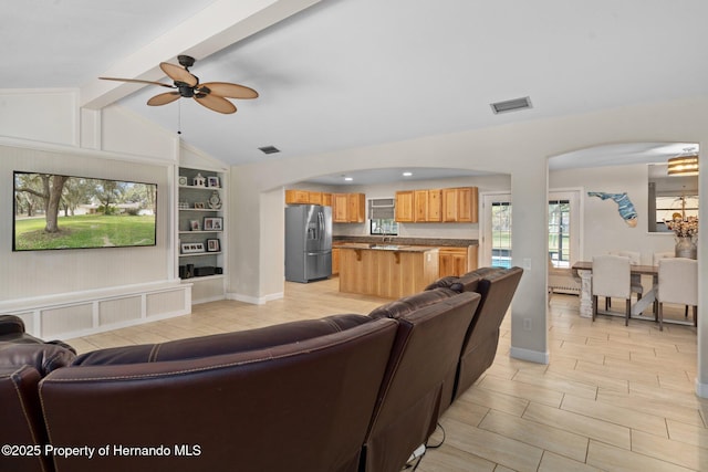 living room with lofted ceiling with beams, sink, and ceiling fan