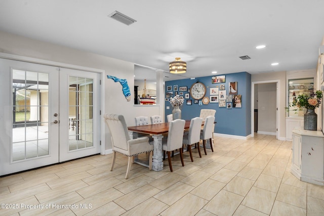 dining space featuring french doors