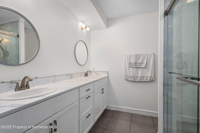 bathroom featuring walk in shower, vanity, and tile patterned flooring