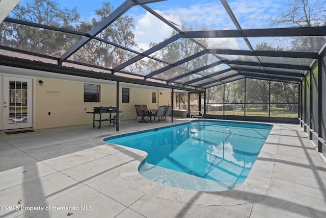 view of pool with a lanai and a patio area