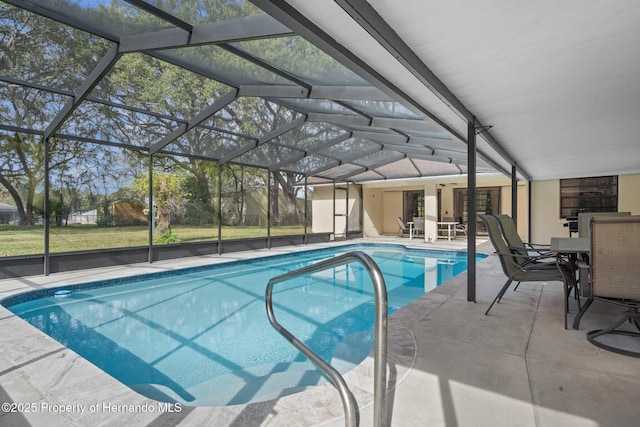 view of swimming pool with a patio and glass enclosure