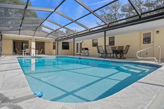 view of pool with a lanai and a patio area