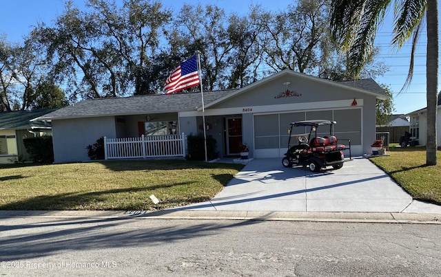 ranch-style house with driveway, a front lawn, an attached garage, and stucco siding