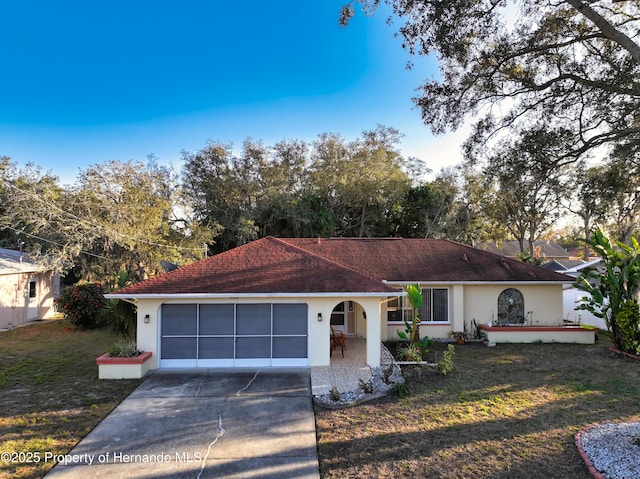 ranch-style home with a front lawn and a garage