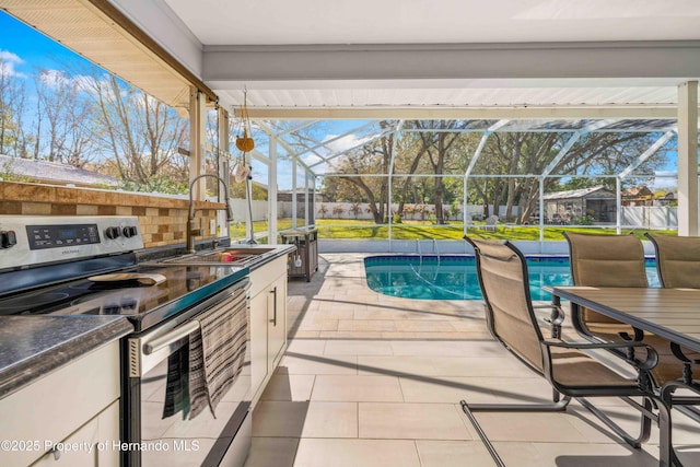exterior space with area for grilling, a lanai, sink, and a patio