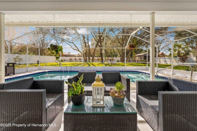 view of swimming pool featuring a patio area and glass enclosure