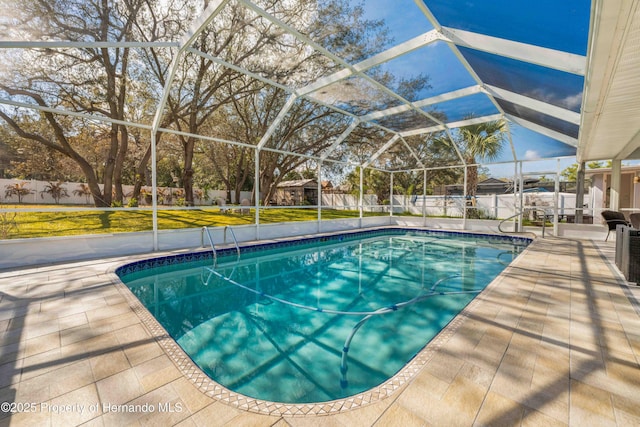 view of pool featuring a patio and glass enclosure