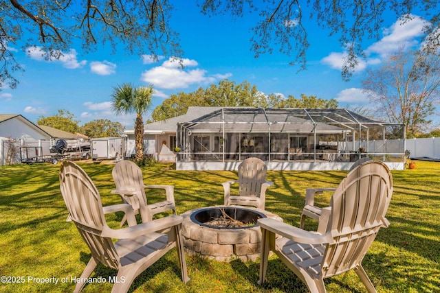 view of yard with an outdoor fire pit and glass enclosure
