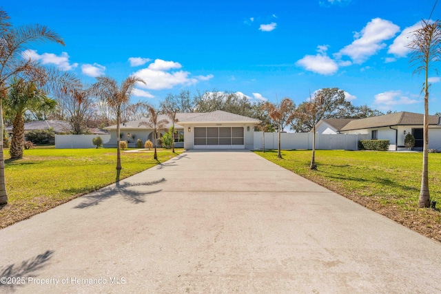 single story home featuring a garage and a front lawn