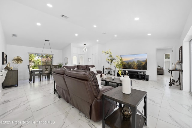 living room featuring lofted ceiling