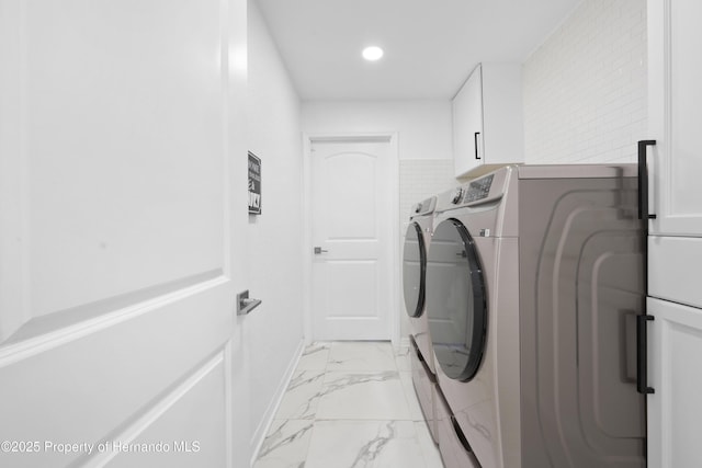 laundry room featuring cabinets and separate washer and dryer