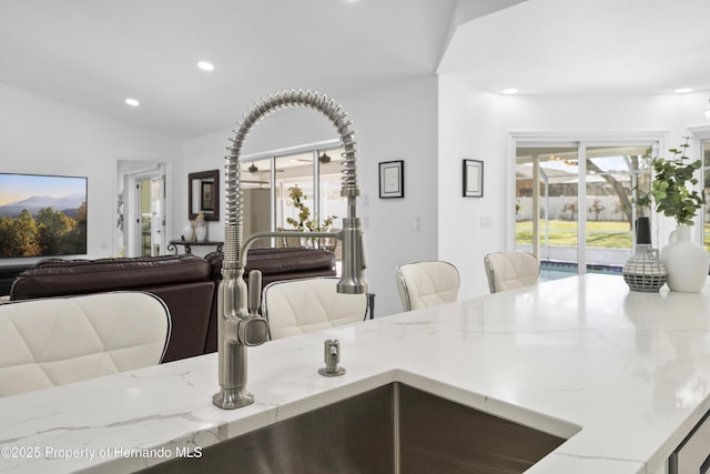 interior space featuring plenty of natural light and vaulted ceiling