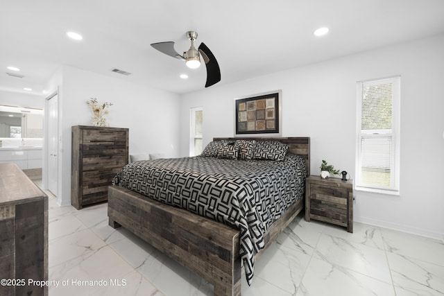 bedroom with ensuite bath and ceiling fan