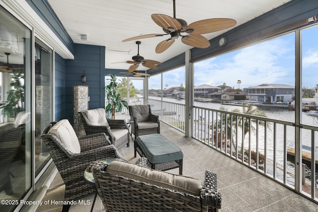 view of patio / terrace featuring a balcony, a water view, and ceiling fan