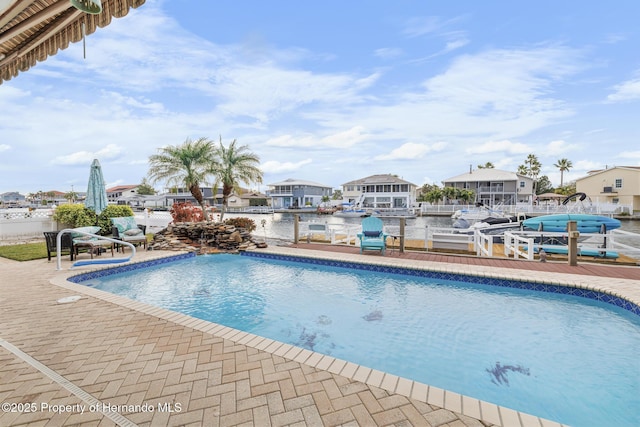 view of swimming pool with a water view