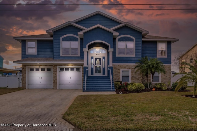 view of front facade featuring a garage and a lawn