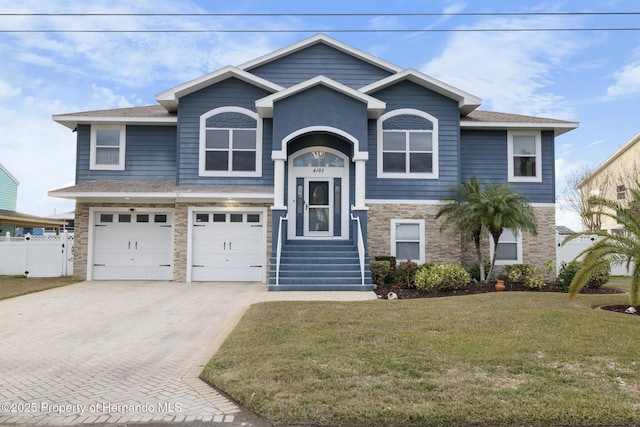 view of front of home featuring a garage and a front lawn