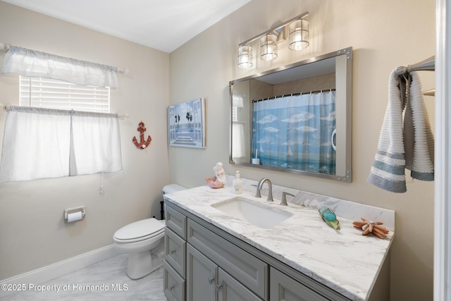 bathroom featuring vanity, toilet, and a shower with shower curtain