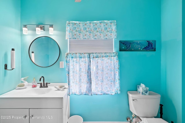 bathroom featuring vanity and toilet