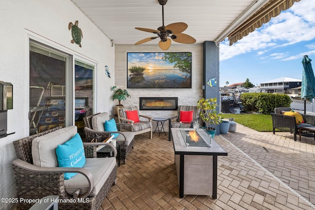 view of patio / terrace with an outdoor living space with a fireplace