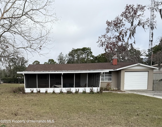 view of front facade featuring a garage, a front yard, and a sunroom