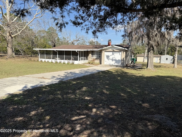 view of front of house featuring a front yard and a sunroom