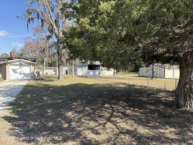 view of yard with a garage and an outdoor structure