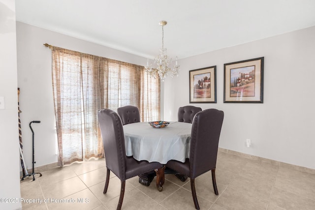 dining area featuring a chandelier and light tile patterned floors