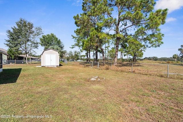 view of yard with a shed and a rural view