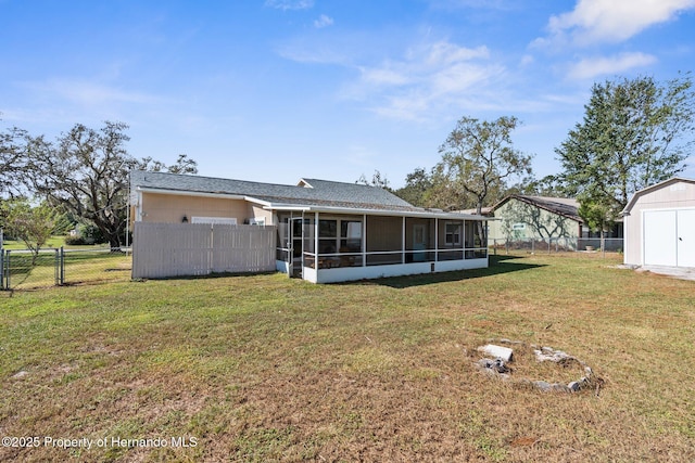 back of house featuring a yard and a sunroom