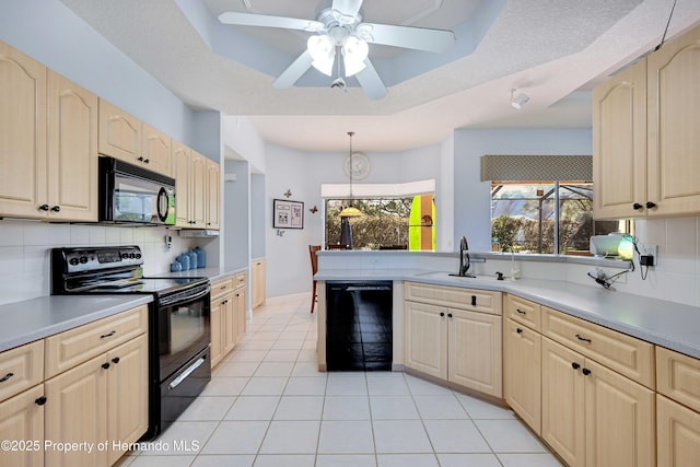 kitchen with sink, decorative light fixtures, light brown cabinets, a tray ceiling, and black appliances