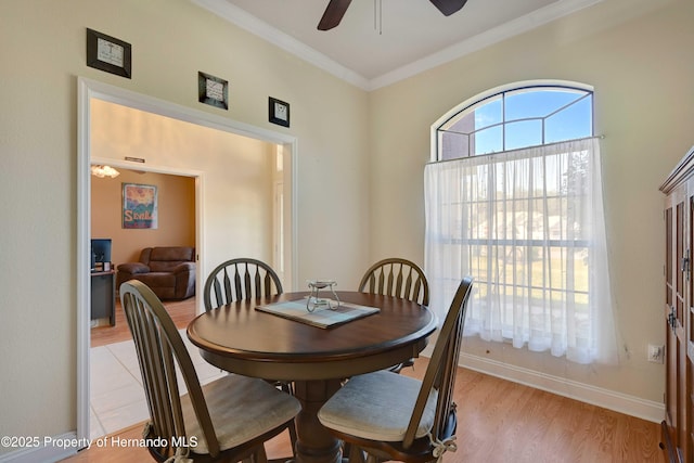 dining room with crown molding, ceiling fan, and light hardwood / wood-style floors