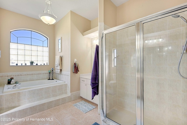 bathroom featuring tile patterned floors and independent shower and bath